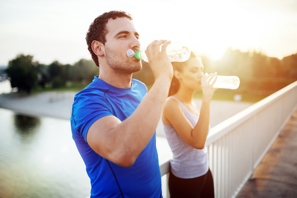 Couple staying hydrated after workout